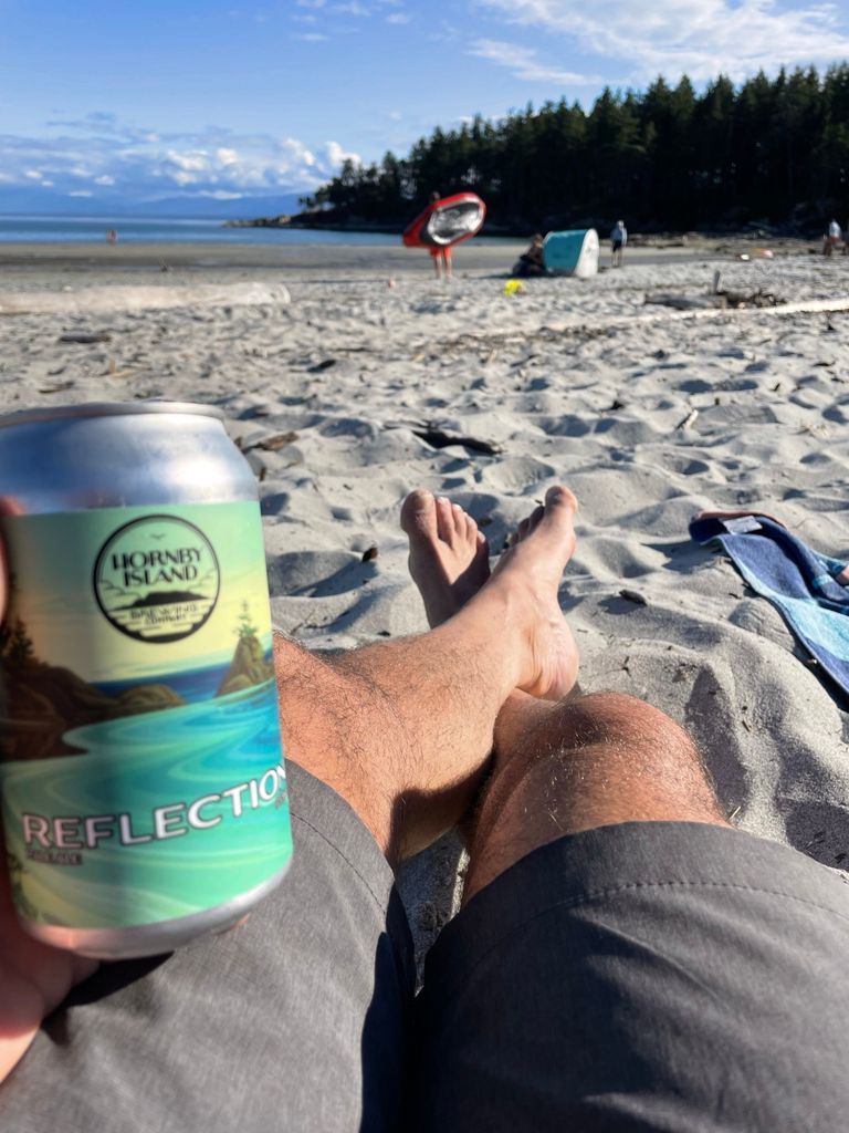Relaxing with a beer at Big Tribune Bay beach