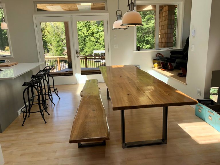 dining room table with kitchen island, french doors, and deck in the background