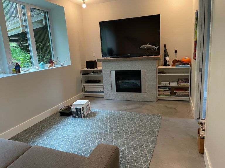 family room with pullout couch, TV, toys, and games